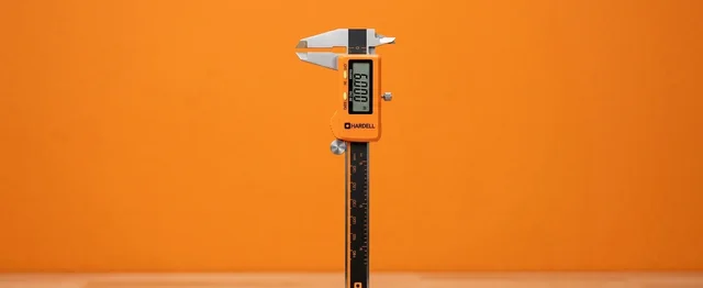ACCUMEASURE digital caliper being used for precise measurement in a studio environment