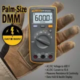 Fluke 107 digital multimeter held in a gloved hand, showcasing its compact size and display features.
