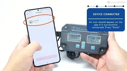 Hands holding a smartphone and a digital water quality monitoring device showing a successful device connection screen.