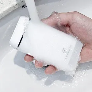 Close-up of a compact water flosser highlighting the ergonomic design and build quality.